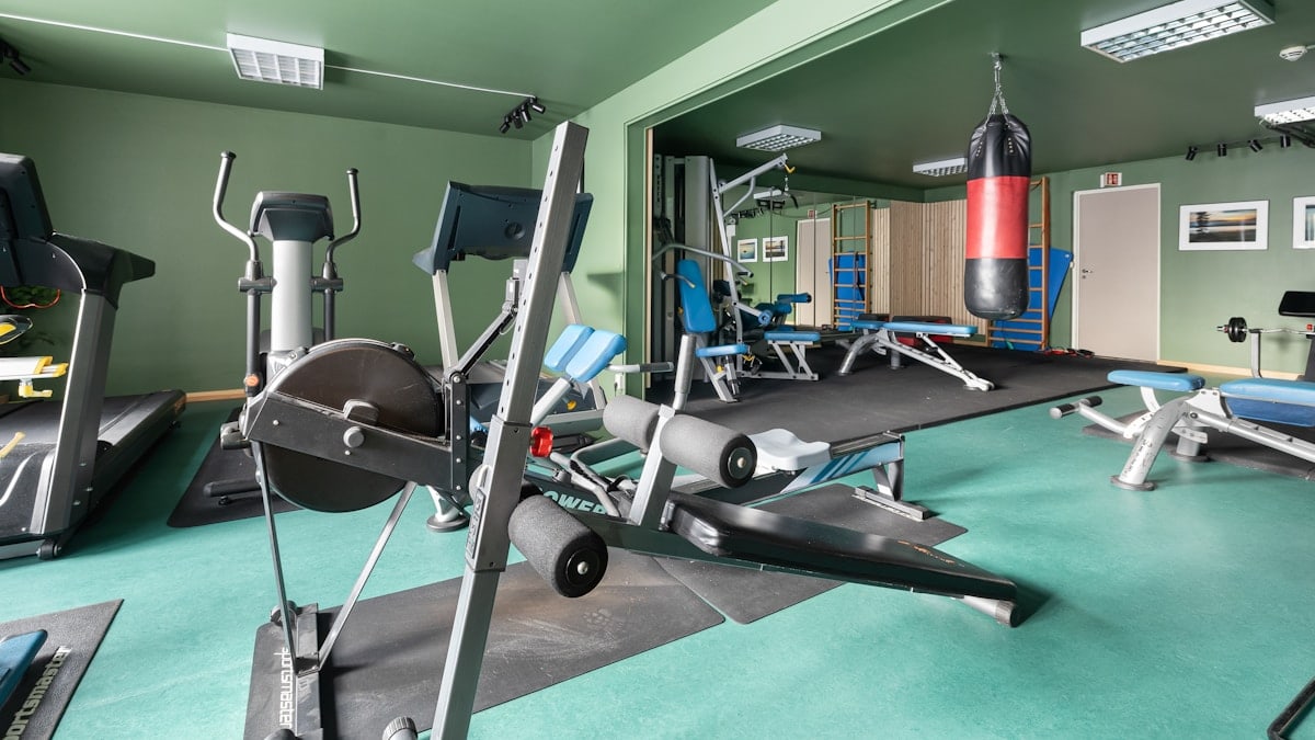 A gym with a variety of exercise equipment